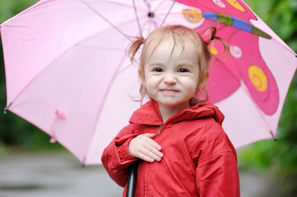 Adorable toddler girl at rainy day in autumn — Stock Photo, Image