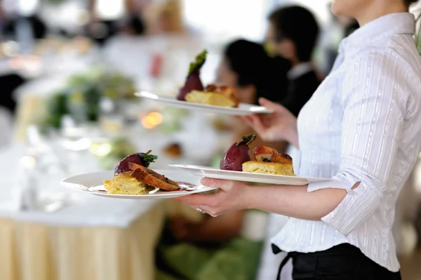 Waitress is carrying three plates — Stock Photo, Image