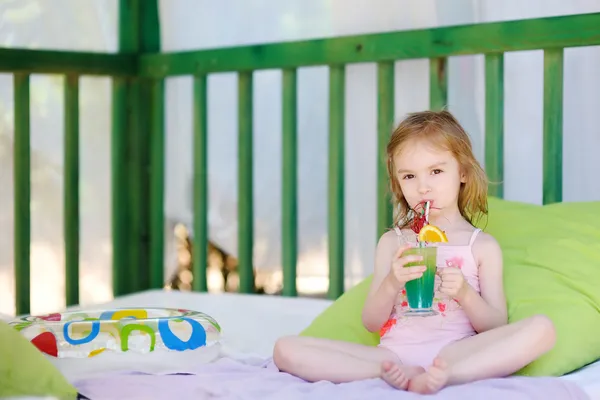 Cute little girl drinking cocktail — Stock Photo, Image