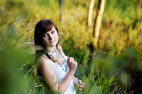 Young beautiful woman at a sunset — Stock Photo, Image