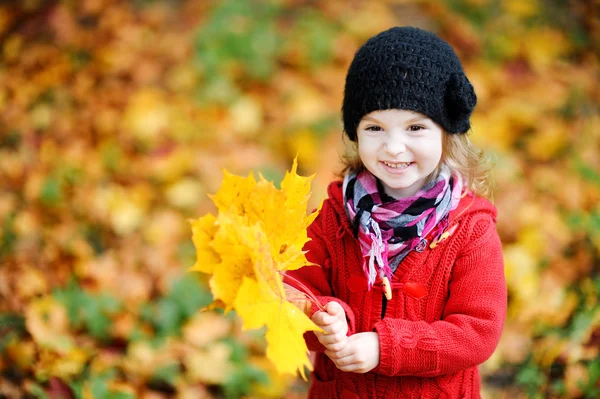 Little girl in bright red coat at autumn — Stock Photo, Image