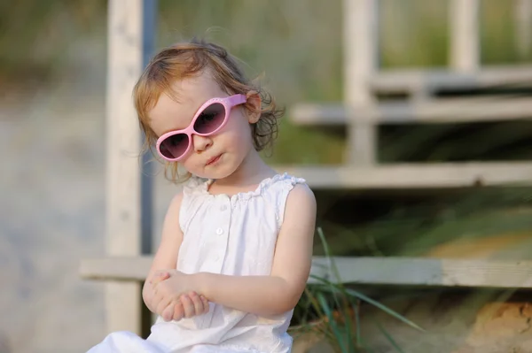 Adorable toddler girl sitting on the stairs — Stock Photo, Image