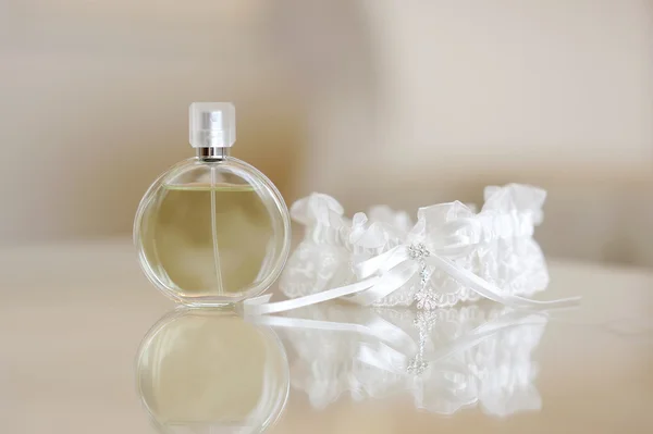 Perfume and a garter — Stock Photo, Image