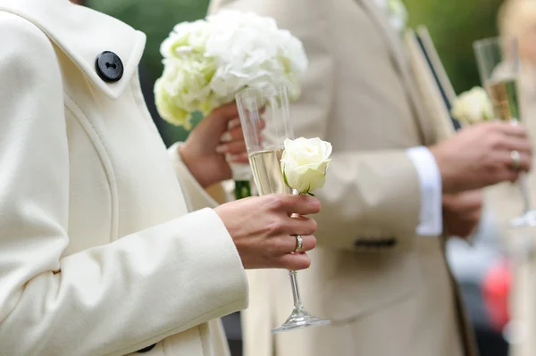 Bruden och brudgummen håller champagneglas — Stockfoto