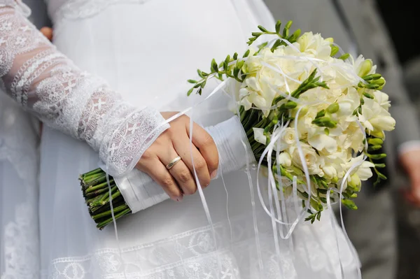 Bride holding freesia flowers — Stock Photo, Image