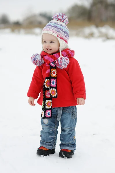 Little winter baby girl in red coat — Stock Photo, Image