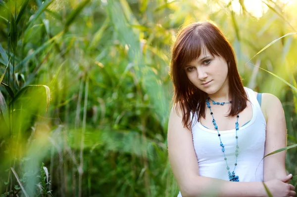 Young beautiful woman at a sunset — Stock Photo, Image