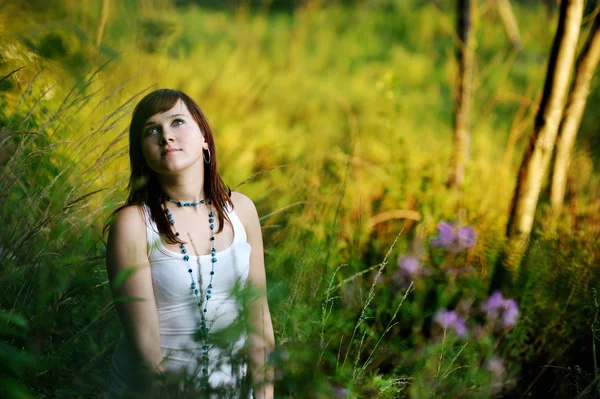 Young beautiful woman at a sunset — Stock Photo, Image