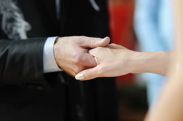 Braut und Bräutigam halten sich die Hand — Stockfoto