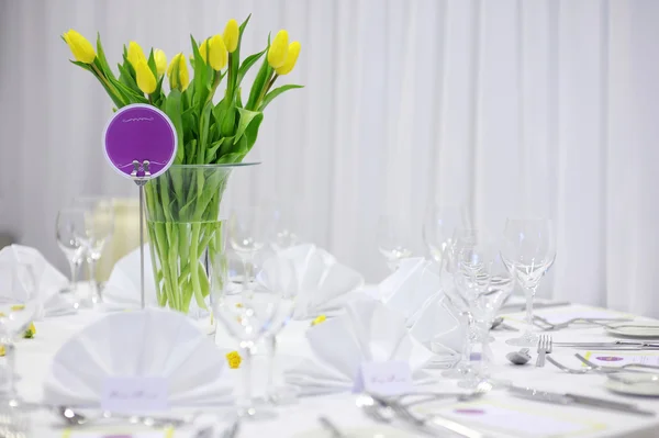 Beautiful yellow tulips on a festive table — Stock Photo, Image