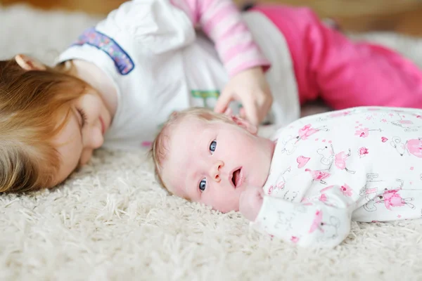 Little girl and her newborn sister Stock Photo