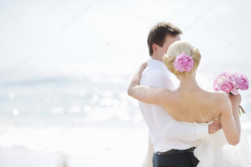 Bride and groom by the sea