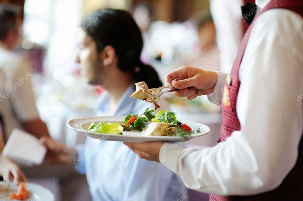 Waiter carrying a plate