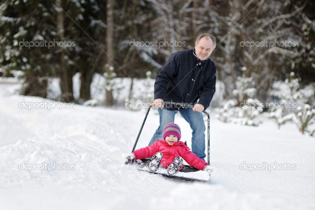 Winter fun: having a ride on a snow shovel