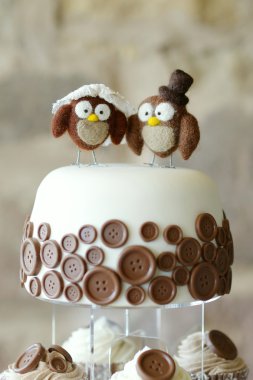 Decorative owls on top of a wedding cake clipart