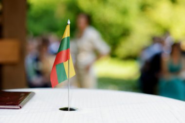 Lithuanian flag on a table clipart