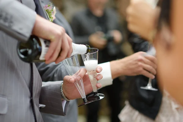 Pouring champagne into a glasses — Stock Photo, Image
