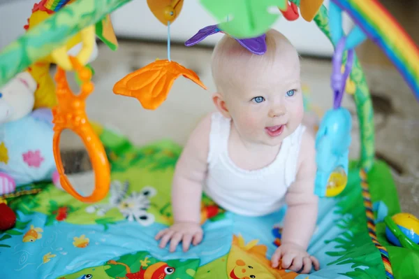 Baby girl playing with soft toys — Stock Photo, Image