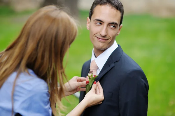 Adjusting groom's boutonniere — Stock Photo, Image