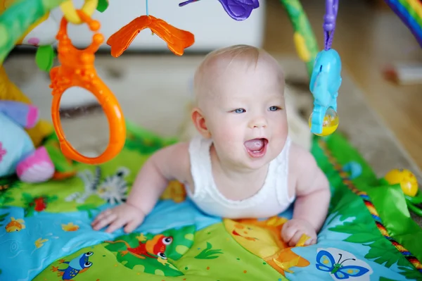 Baby girl playing with soft toys — Stock Photo, Image