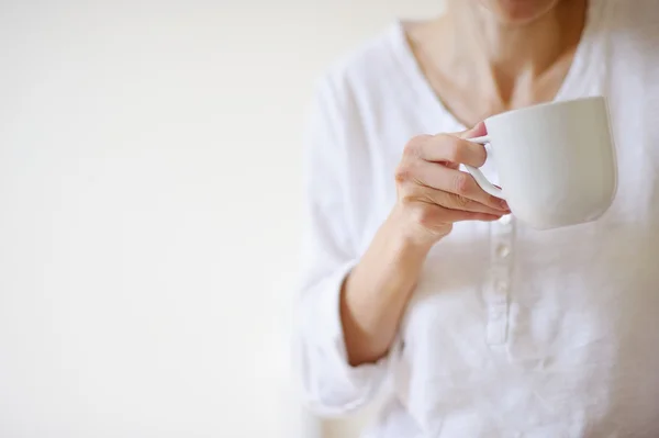 Žena ruku s bílým cup na bílém pozadíNagyító esernyő ikon és adatok védelméről szó — Stock fotografie