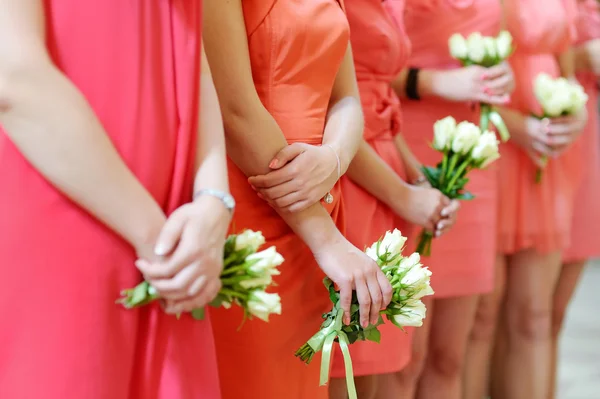 Row of bridesmaids with bouquets — Stock Photo, Image