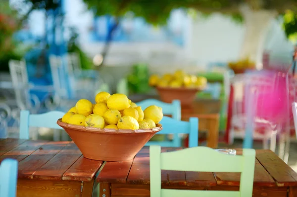 A dish of lemons in typical greek outdoor cafe — Stock Photo, Image