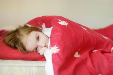 Little preschooler girl in bed clipart
