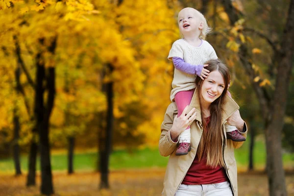 Junge Mutter und Kleinkind amüsieren sich im Herbst — Stockfoto