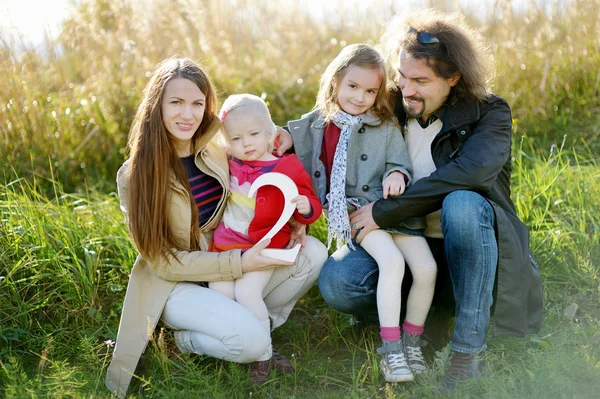 Family of four celebrating daughter's birthday — Stock Photo, Image