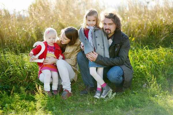 Family of four celebrating daughter's birthday — Stock Photo, Image