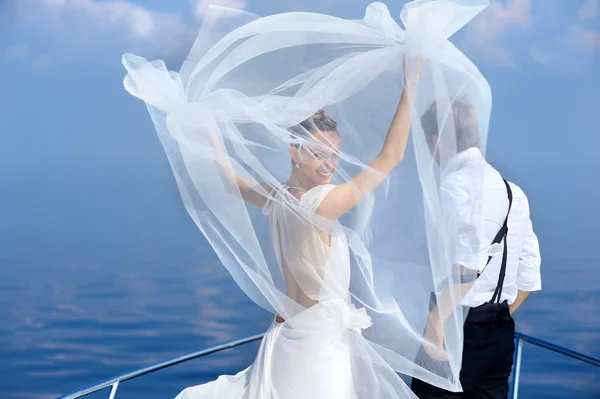 Happy bride and groom on a yacht — Stock Photo, Image