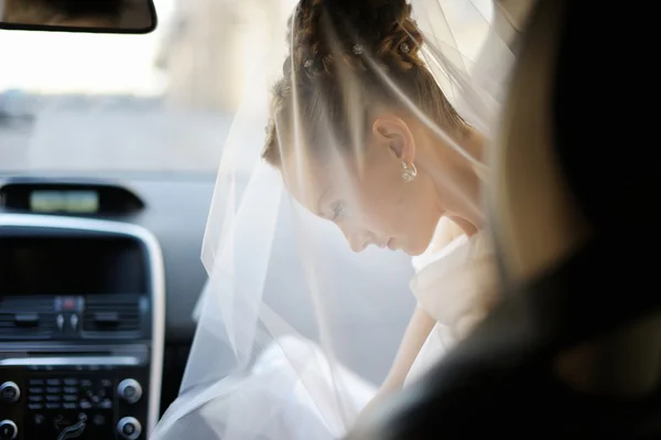 Gyönyörű fiatal menyasszony portré egy autó — Stock Fotó