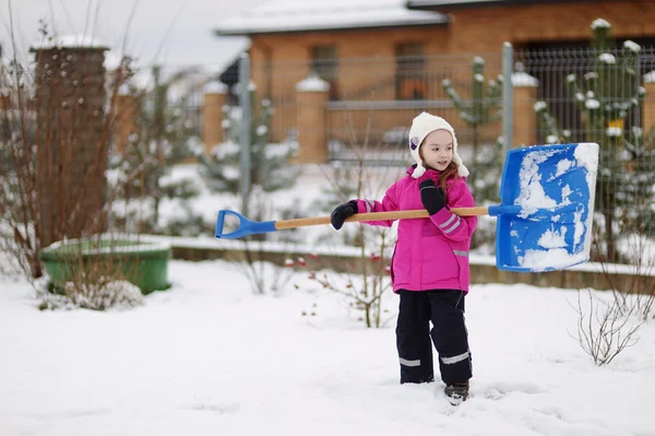 A girl takes pride in completing a shoveling job — Stock Photo, Image