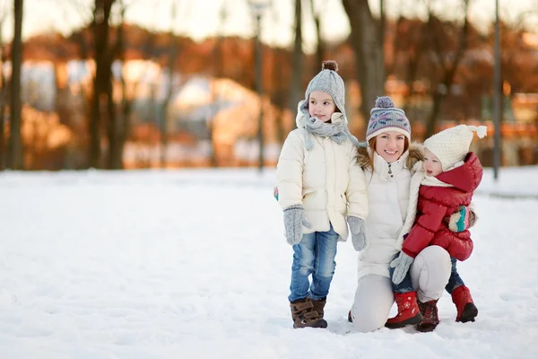 Giovane madre e le sue figlie in un giorno d'inverno — Foto Stock