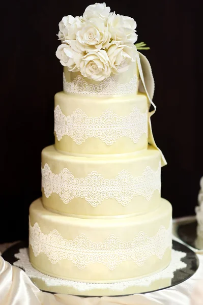 White wedding cake decorated with white lace — Stock Photo, Image