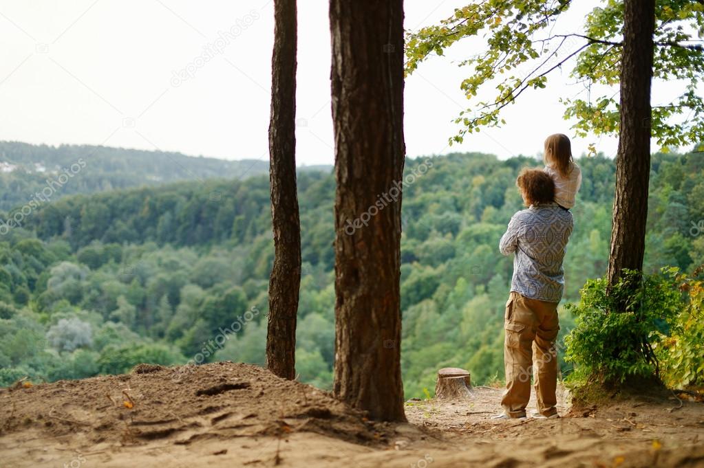 A girl and her father standing on the edge