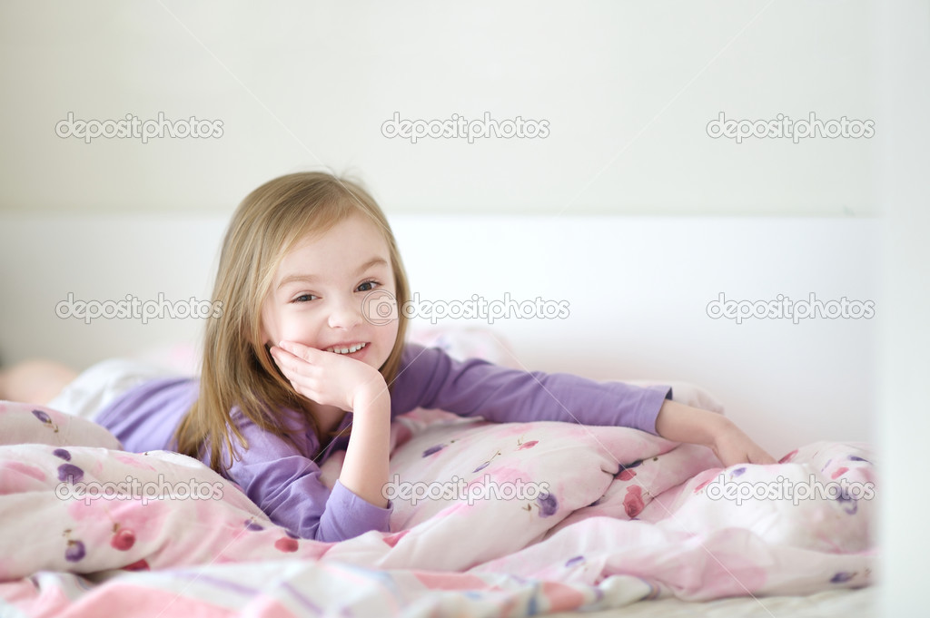 Little girl in pajamas on sunny morning