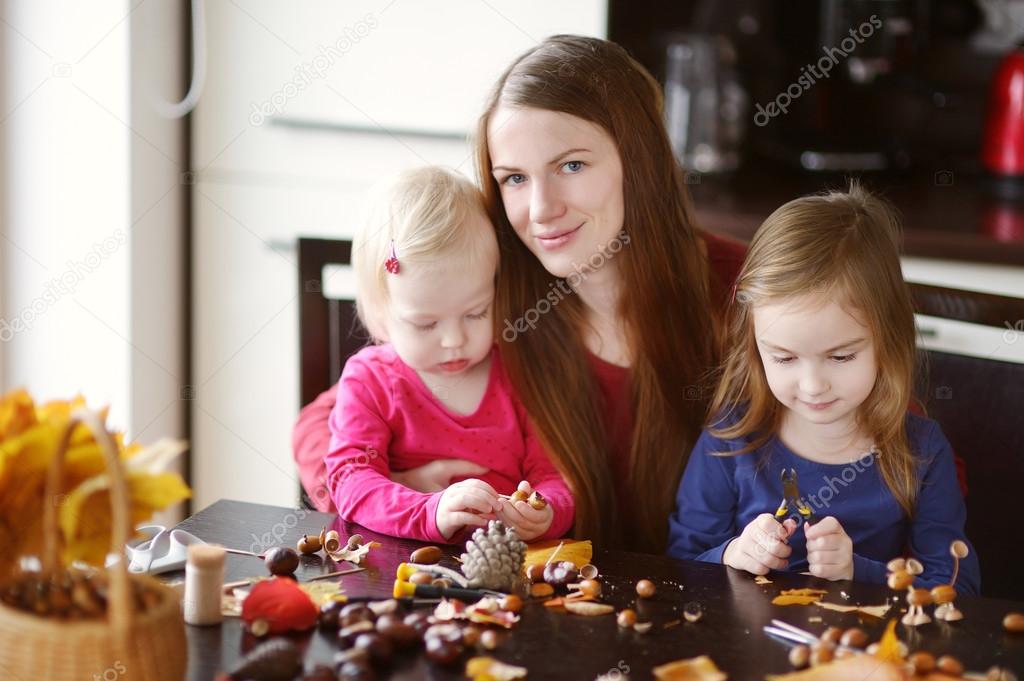 Mother and her kids making chestnuts creatures