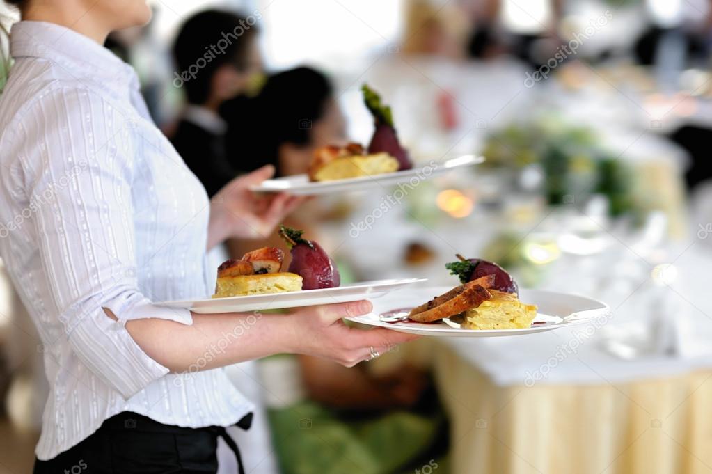 Waitress is carrying three plates