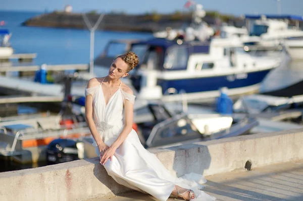 Hermosa novia posando en un puerto — Foto de Stock