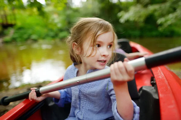 Bonne petite fille sur un kayak sur une rivière — Photo