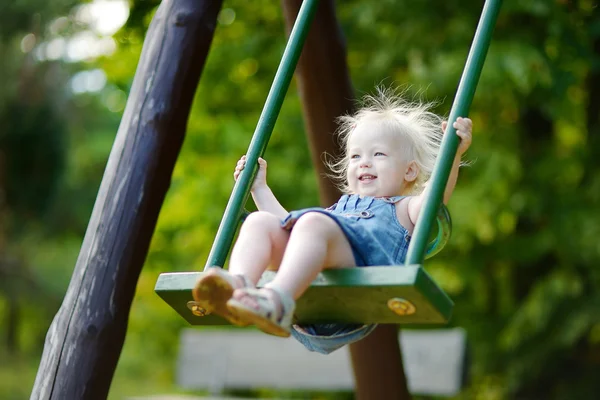 Adorable girl having fun on a swing — Stock Photo, Image