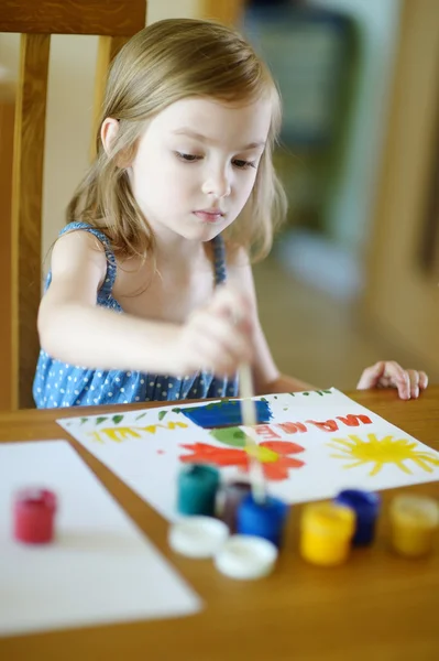 Cute little girl is drawing with paints — Stok fotoğraf