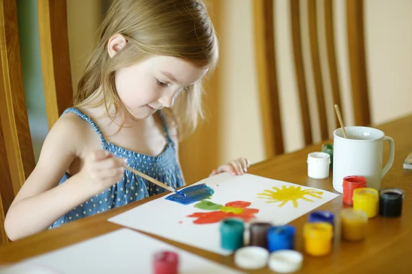 Cute little girl is drawing with paints — Stok fotoğraf