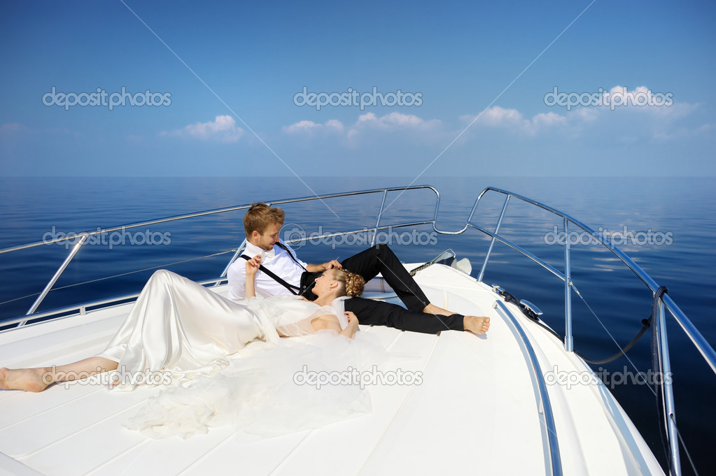 Happy bride and groom on a yacht