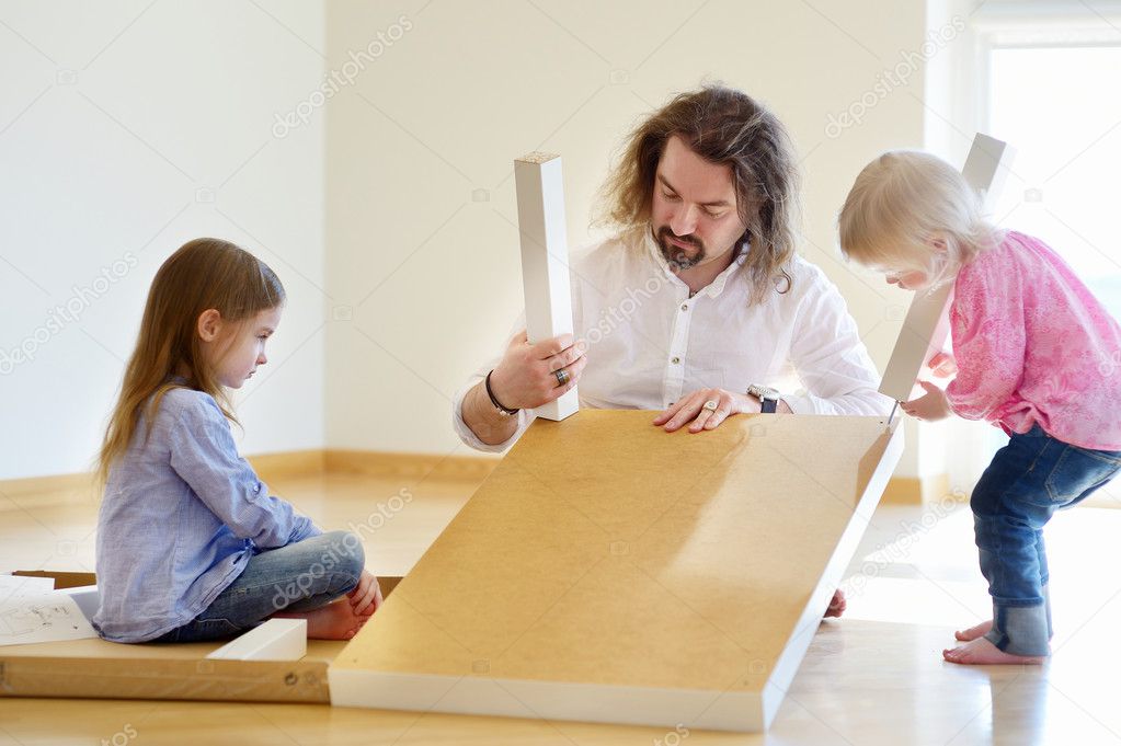 Father and daughters assembling table