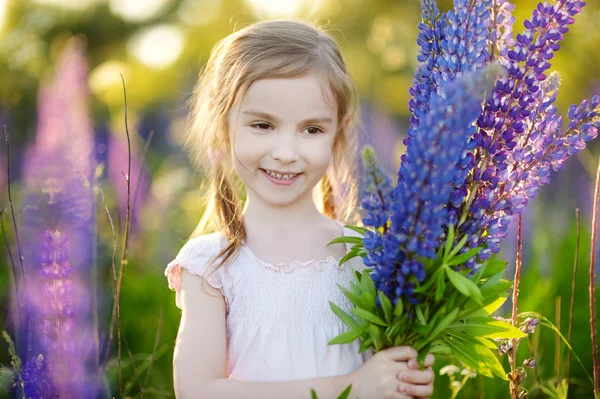 Girl in lupine field — Stock Photo, Image