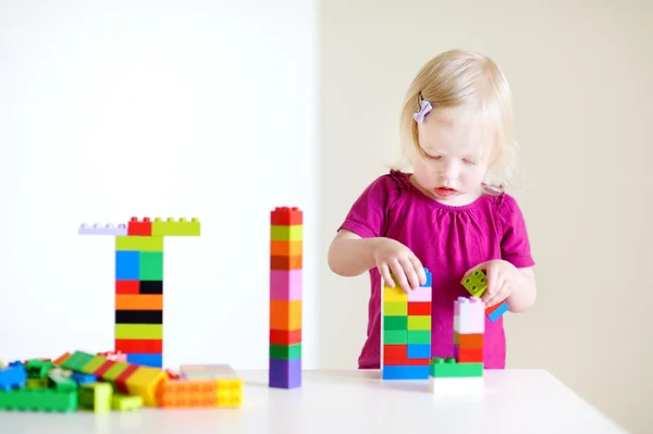 Girl playing with plastic blocks — Stock Photo, Image