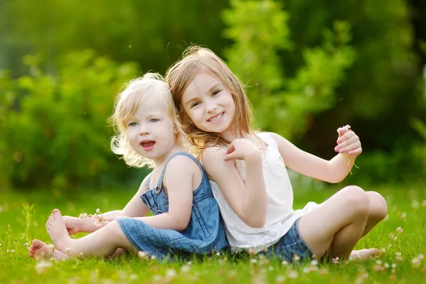 Sisters on grass Stock Photo